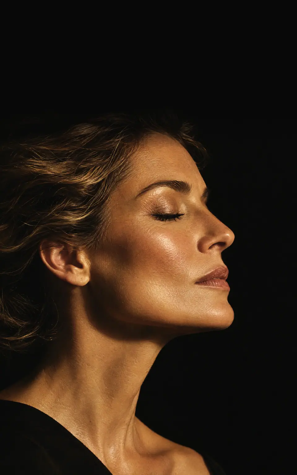 Woman in profile with her eyes closed.